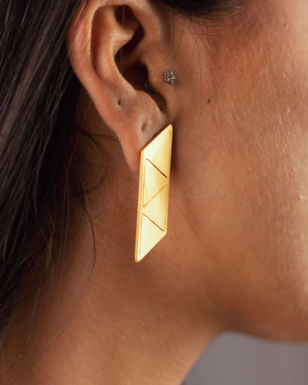 Details des boucles d'oreilles 4 triangles modulables Niléa portés en version plate